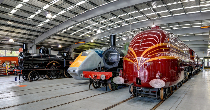 Historic railway engines on display inside Locomotion museum.